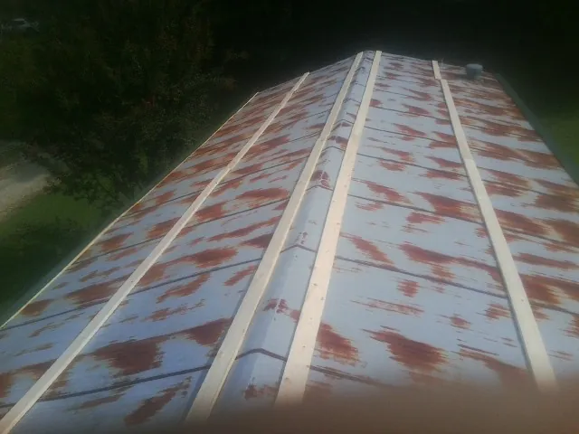 Rusted metal roof panels with new wood purlins before replacement — Storm Damage Roof Repair in West Berlin by Roofing Brothers